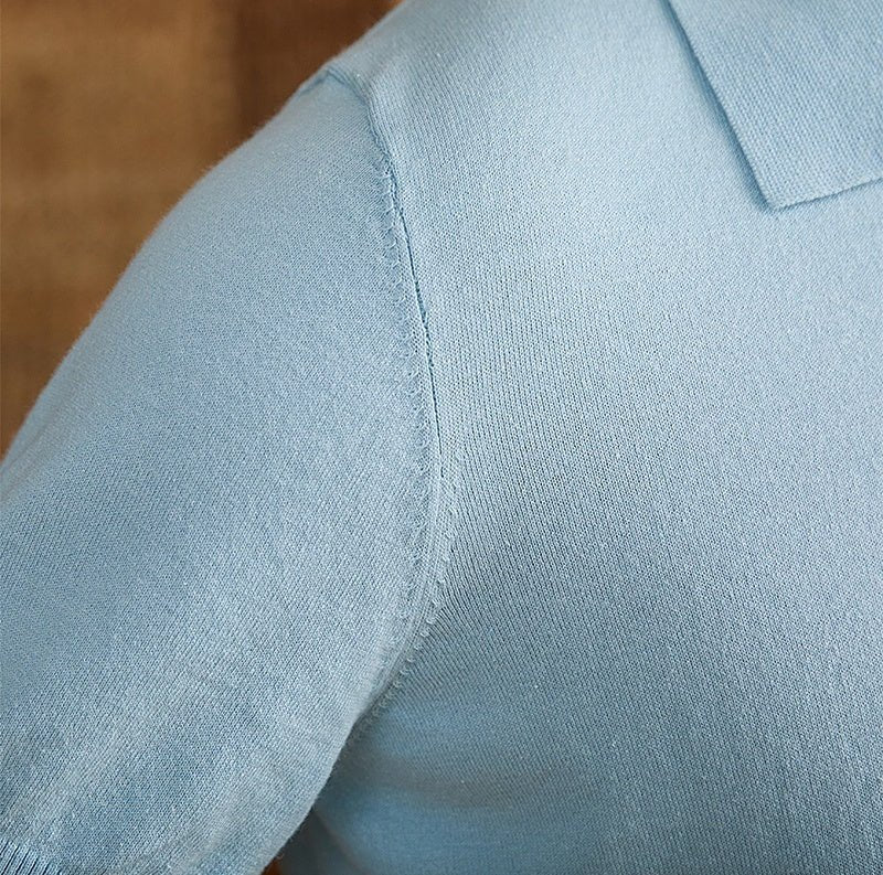 Men's light blue knit polo crafted from a breathable cotton-linen blend, featuring a classic button placket and ribbed hem.