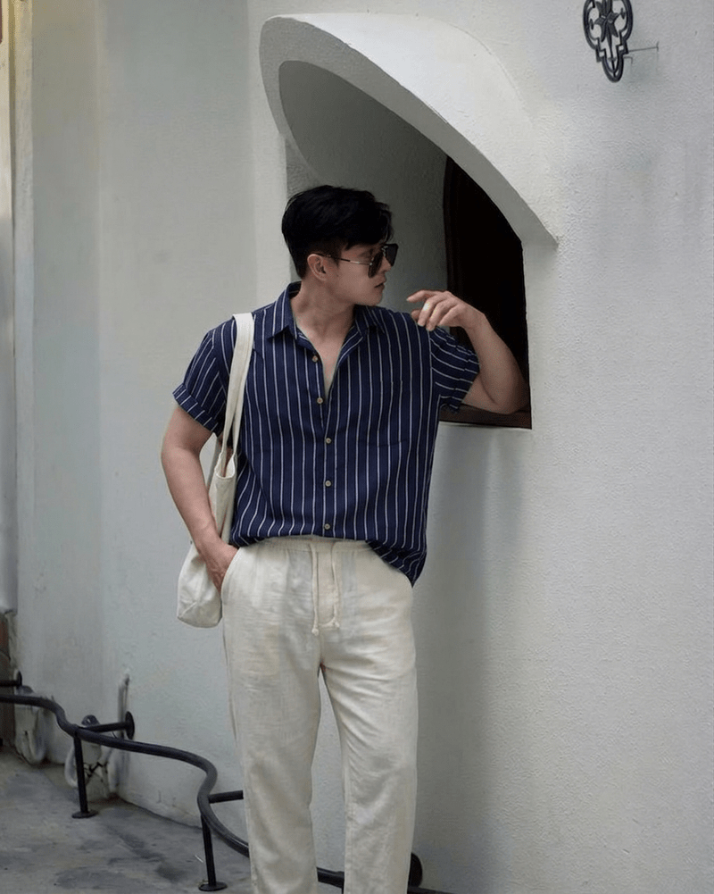 Men's navy blue linen-blend set featuring a short-sleeved shirt with vertical texture and matching pants.