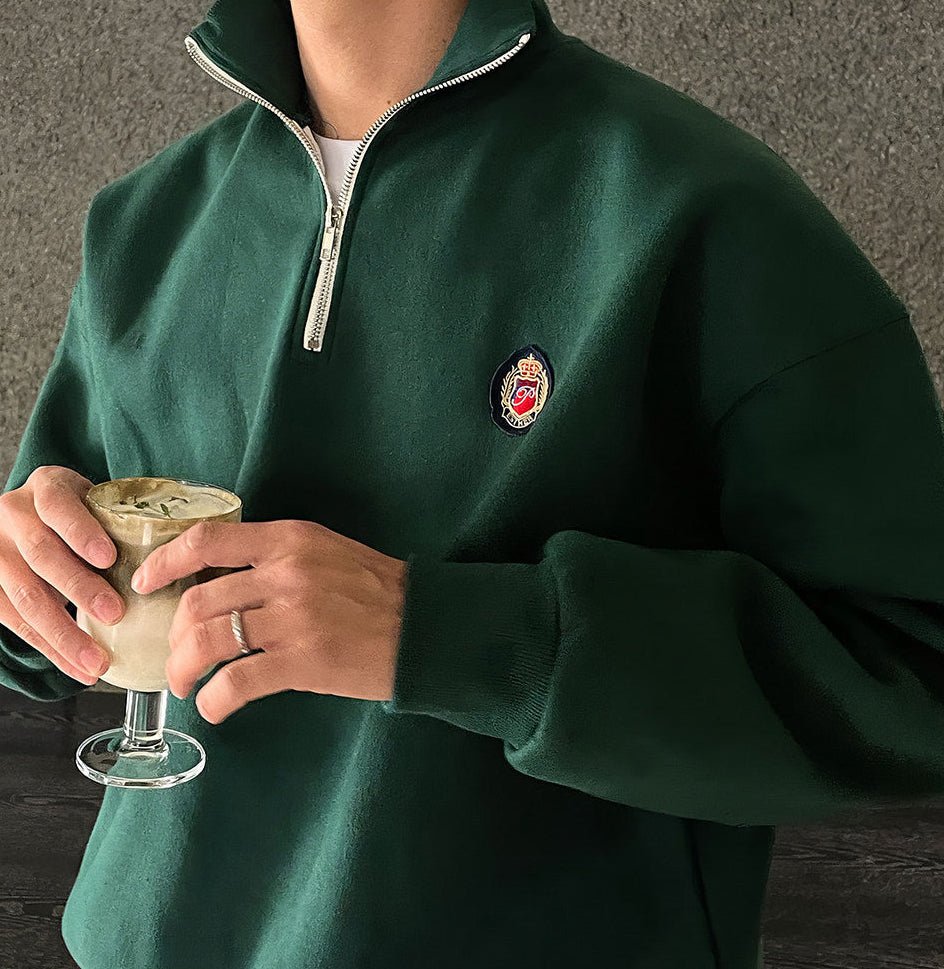 Deep green loose-fit quarter-zip sweatshirt for men with a modern high-neck design and soft-touch finish.