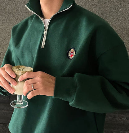 Deep green loose-fit quarter-zip sweatshirt for men with a modern high-neck design and soft-touch finish.