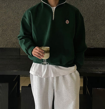 Deep green loose-fit quarter-zip sweatshirt for men with a modern high-neck design and soft-touch finish.