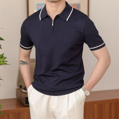 Men's navy blue knitted quarter-zip polo with a white contrast tipped collar and matching white sleeve trim.