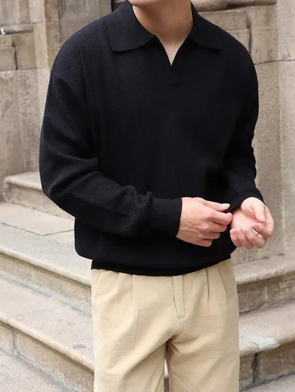 Classic black buttonless V-neck long sleeve polo for men, showcasing a breathable textured weave and relaxed professional silhouette.
