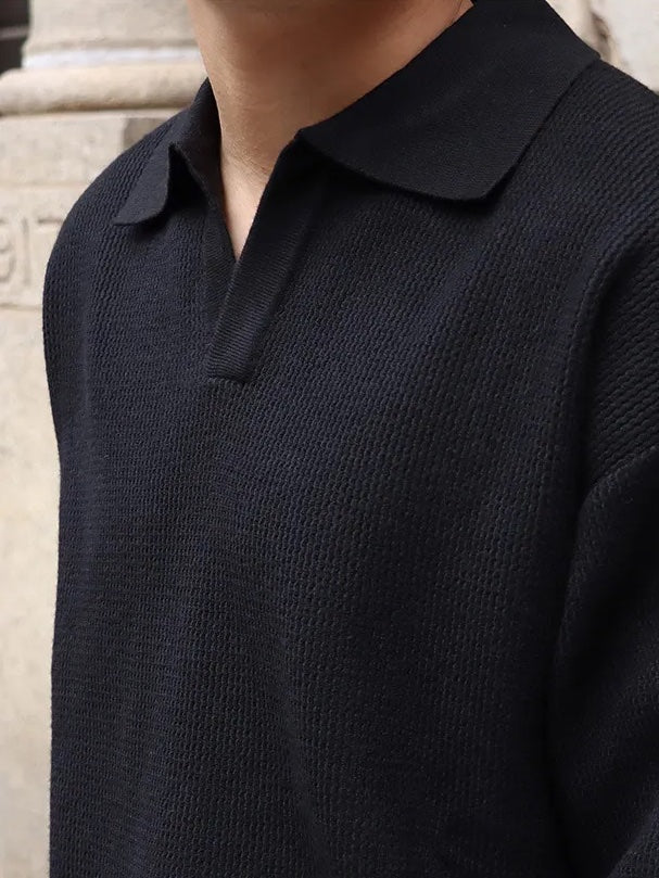 Classic black buttonless V-neck long sleeve polo for men, showcasing a breathable textured weave and relaxed professional silhouette.