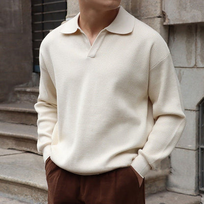 Men's ivory long sleeve buttonless V-neck polo featuring a relaxed fit and premium cotton-poly blend for a comfortable, cool look.