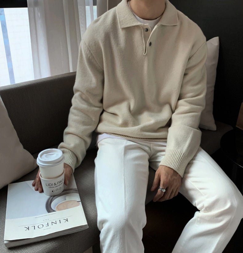 Men's ivory loose-fit buttoned knit polo sweater featuring a smooth cotton-blend and drop-shoulder silhouette.