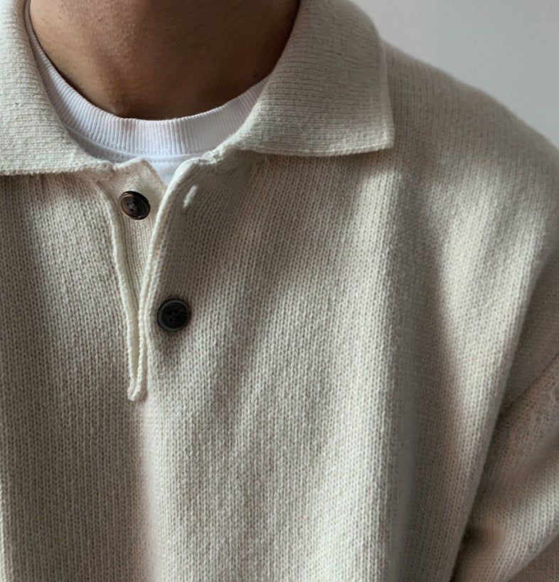 Close-up of the LORMIER button placket and soft spread collar on the ivory knit polo sweater.