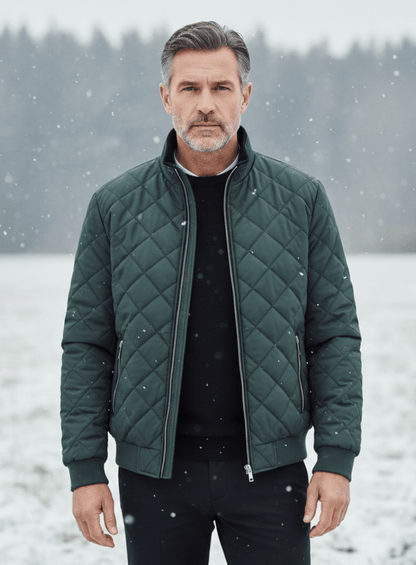 Man wearing a green quilted jacket in a snowy landscape