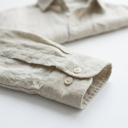Men's beige long sleeve linen shirt featuring a natural textured finish, chest pocket, and classic button-down front.