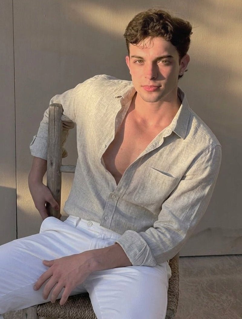 Man wearing a beige long sleeve linen shirt featuring a natural textured finish, chest pocket, and classic button-down front.