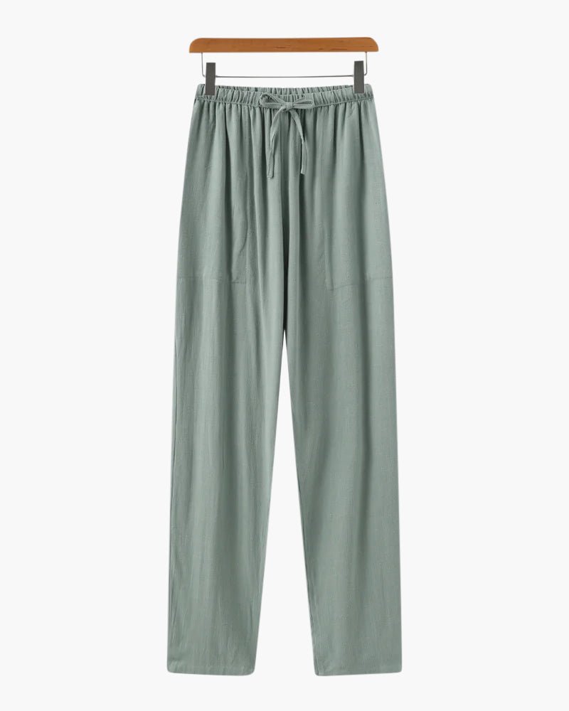 Men's green straight-leg linen trousers showcasing the organic slub texture of premium natural fibers.