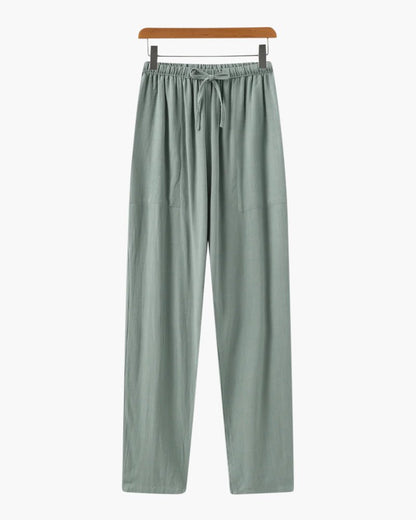 Men's green straight-leg linen trousers showcasing the organic slub texture of premium natural fibers.