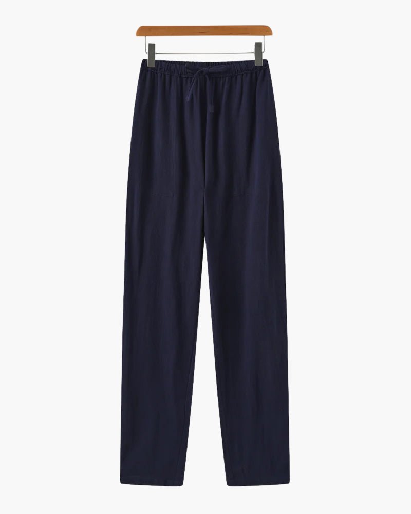 Men's navy blue straight-leg linen pants with a refined architectural drape and functional side pockets.