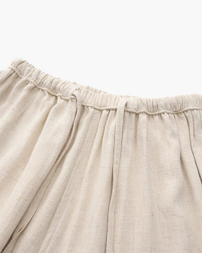 Men's beige straight-leg linen pants featuring a clean structured profile and an adjustable drawstring waistband.