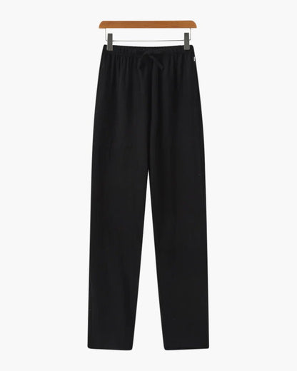 Sophisticated Men's black linen trousers featuring a minimalist straight-cut silhouette for versatile summer styling.
