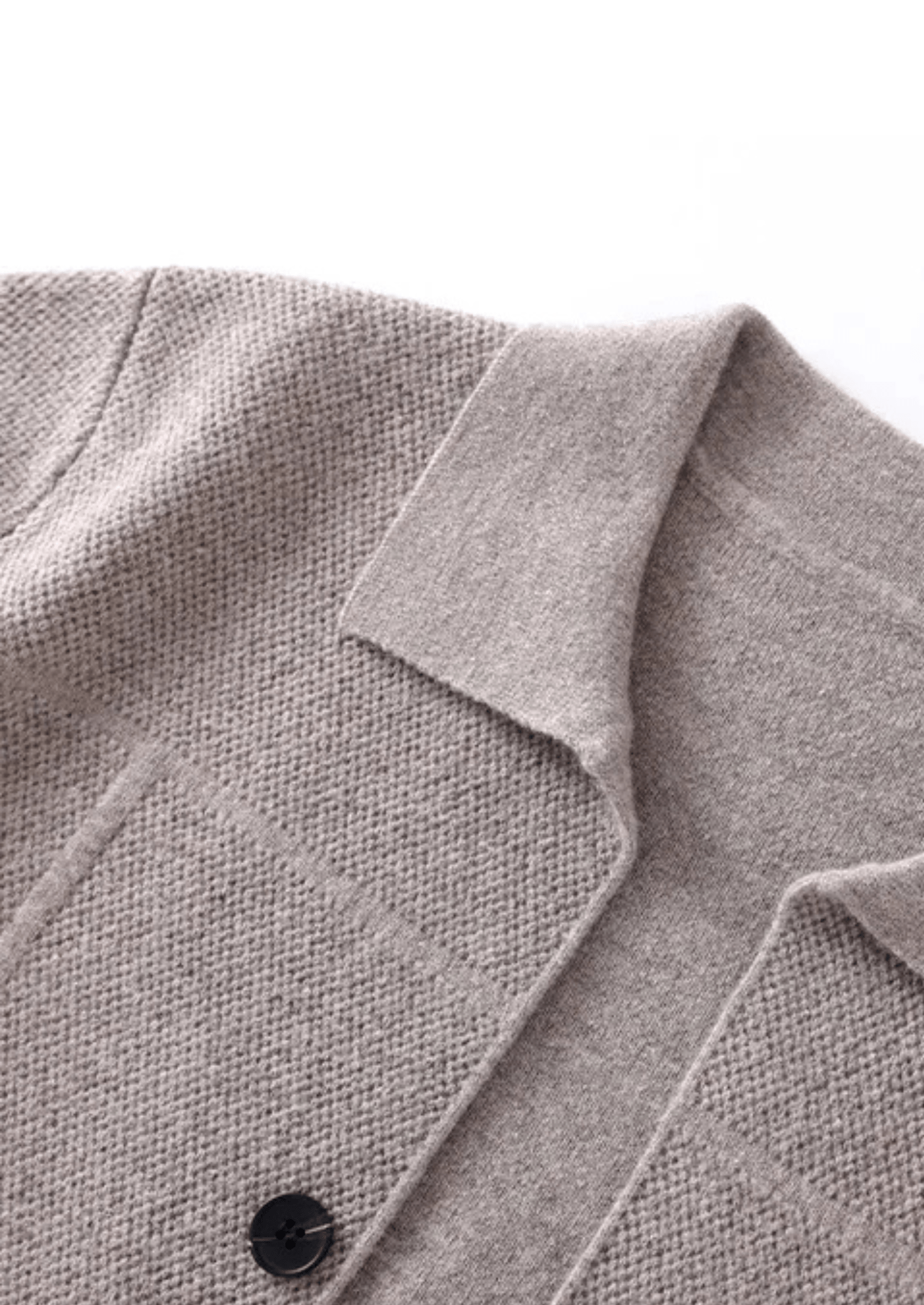 Close-up of a gray coat collar with a button on a white background