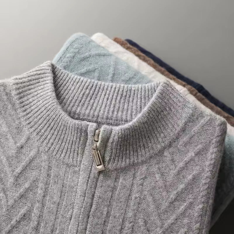 Men’s light gray Merino wool zip sweater featuring a technical chevron cable-knit pattern and a structured ribbed collar.