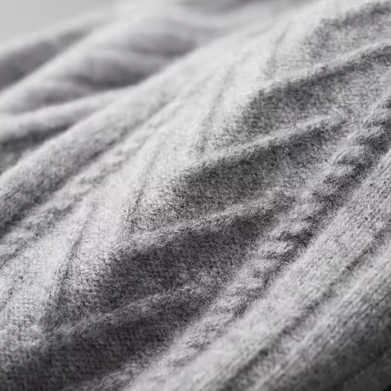 Men’s light gray Merino wool zip sweater featuring a technical chevron cable-knit pattern and a structured ribbed collar.