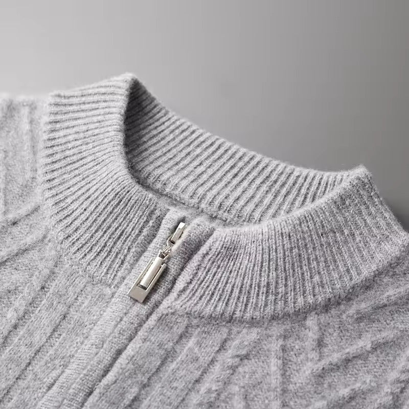 Men’s light gray Merino wool zip sweater featuring a technical chevron cable-knit pattern and a structured ribbed collar.