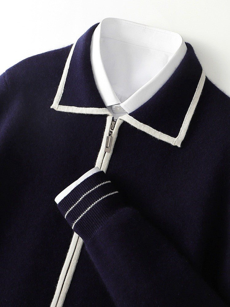 Men's navy blue 100% merino wool polo cardigan featuring white contrast-edge tipping on the collar, zipper, and striped ribbed cuffs.