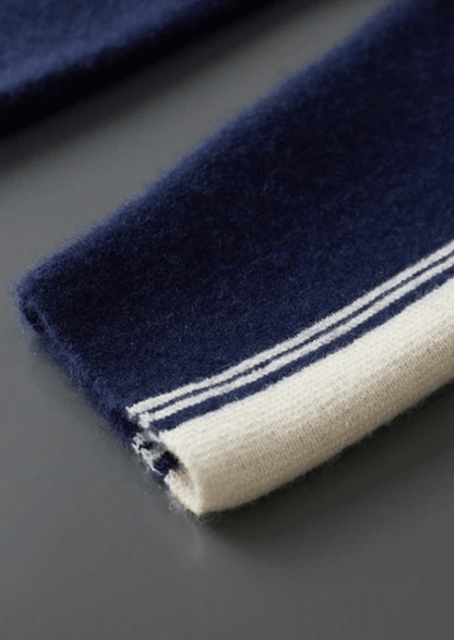 Navy blue towel with white stripes on a dark surface
