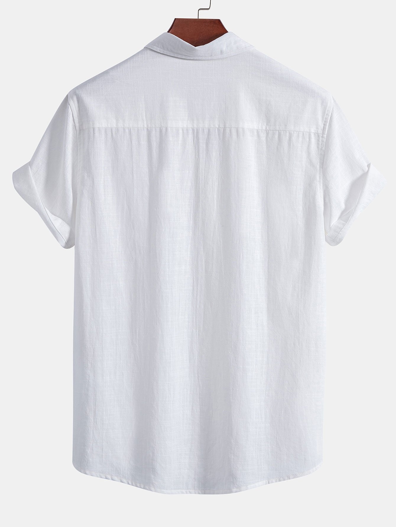 White shirt on a hanger against a white background
