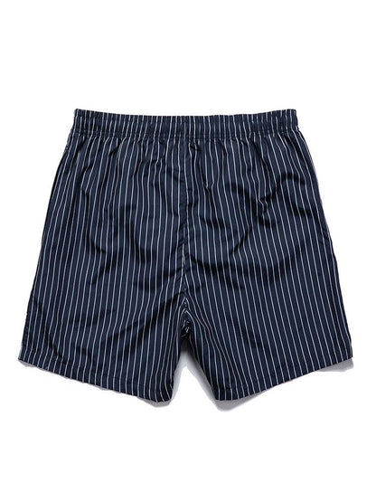 Navy pinstripe shorts on a white background