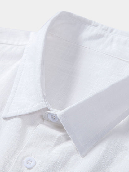 Close-up of a white shirt with a collar and buttons on a light background