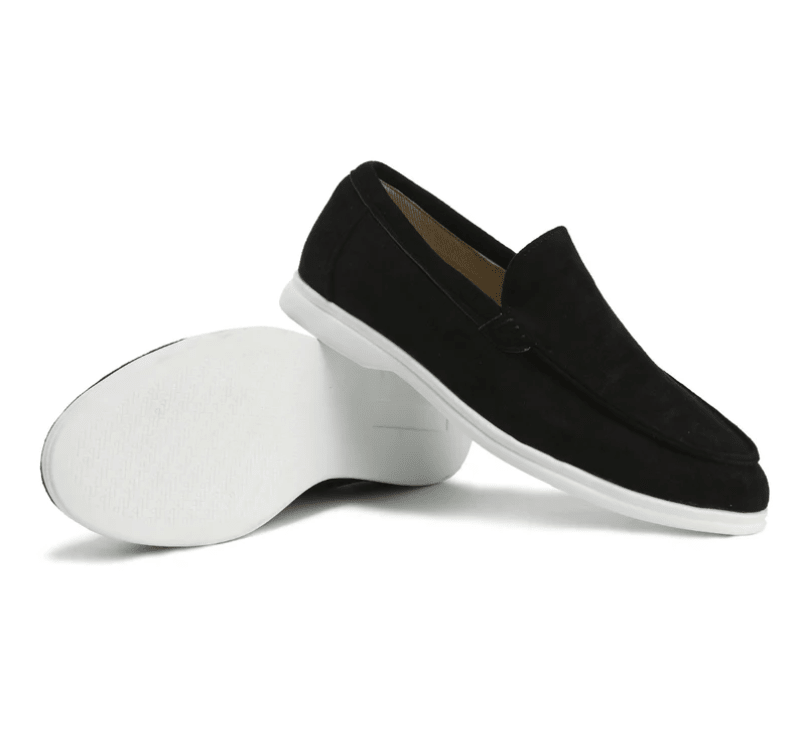 Black loafers with white soles on a white background