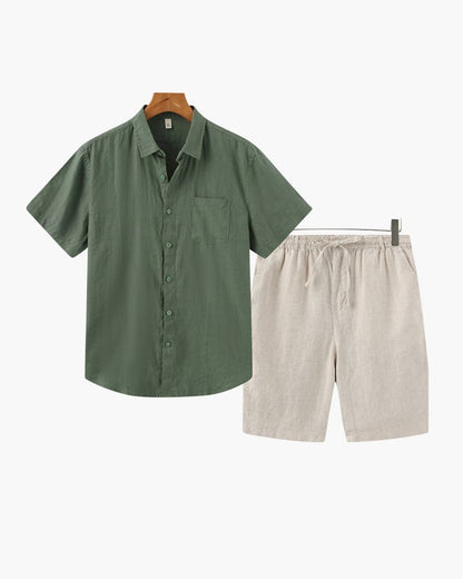 Men's forest green short-sleeved linen shirt paired with beige tailored linen shorts for a refined Mediterranean style.
