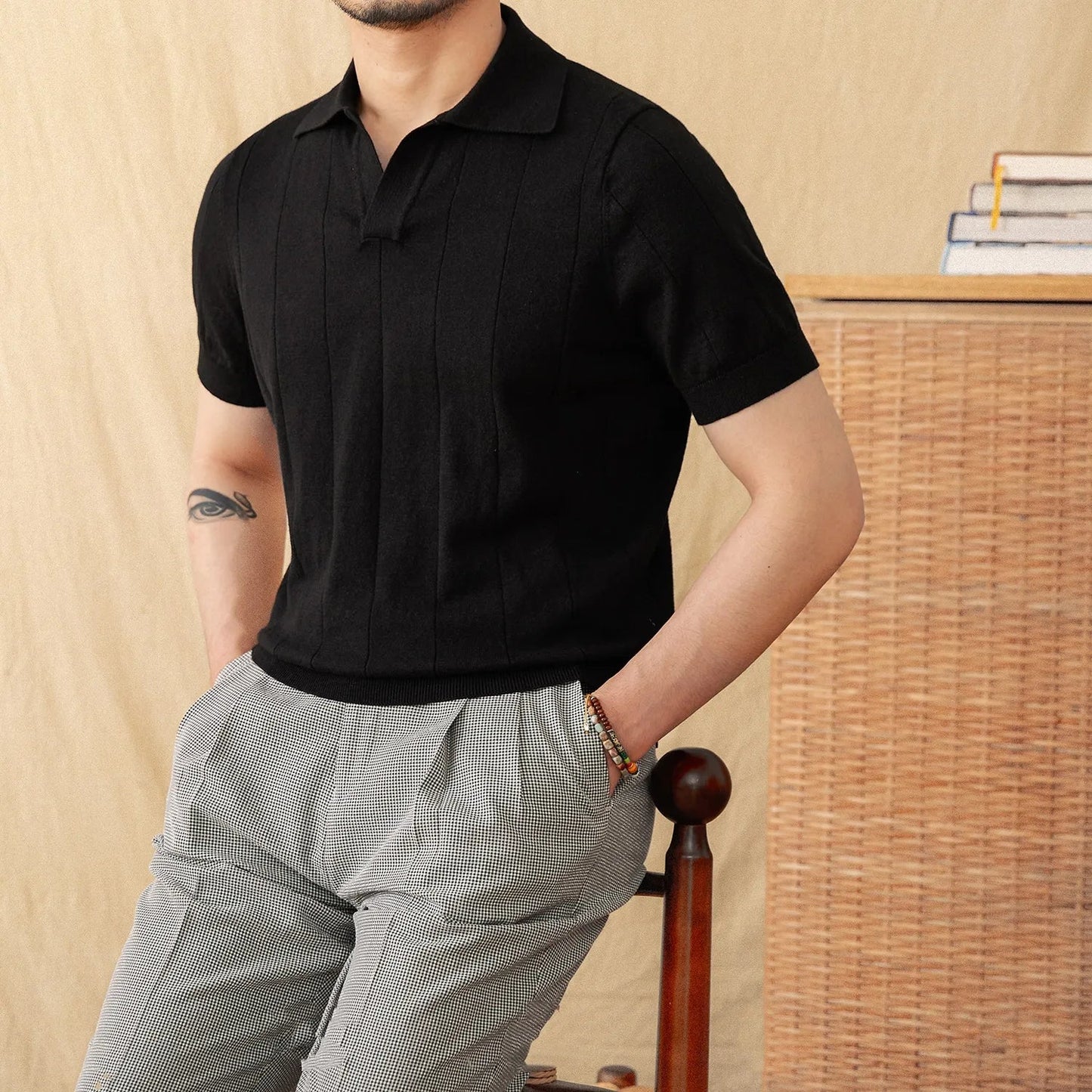 Sophisticated Men's black monochrome ribbed polo showcasing a minimalist architectural texture and a crisp cotton-linen finish.