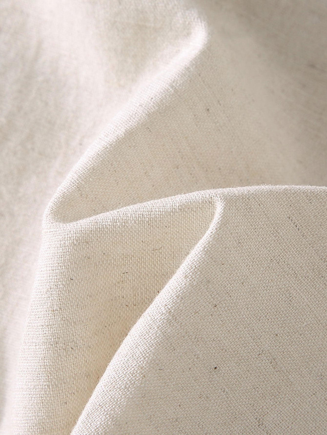 Close-up of beige fabric with natural texture