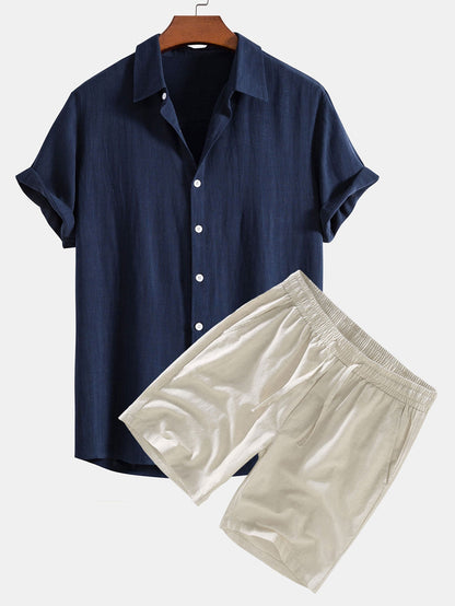 Navy shirt and beige shorts on a white background