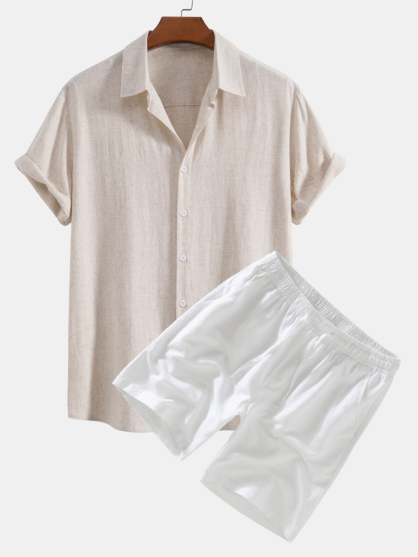 Beige shirt and white shorts on a hanger against a white background