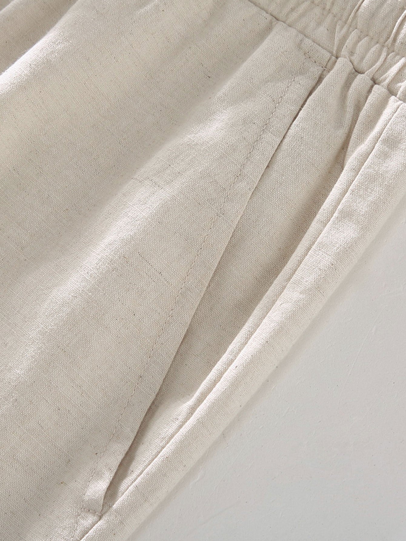 Close-up of beige fabric with a white background
