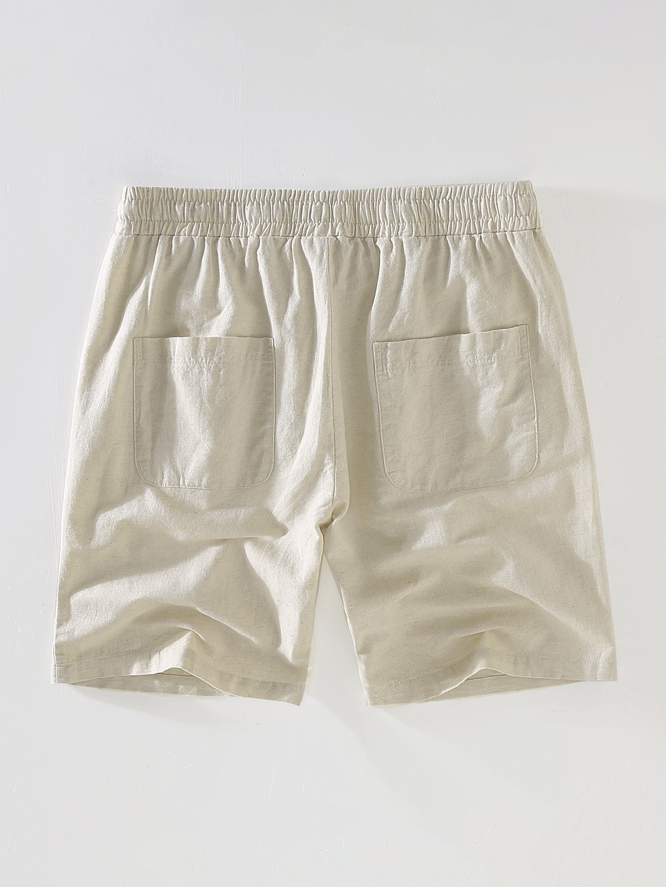 Beige shorts on a light gray background