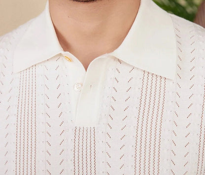 Men's white Pointelle knit polo featuring a sophisticated geometric open-stitch pattern and a classic buttoned neckline.