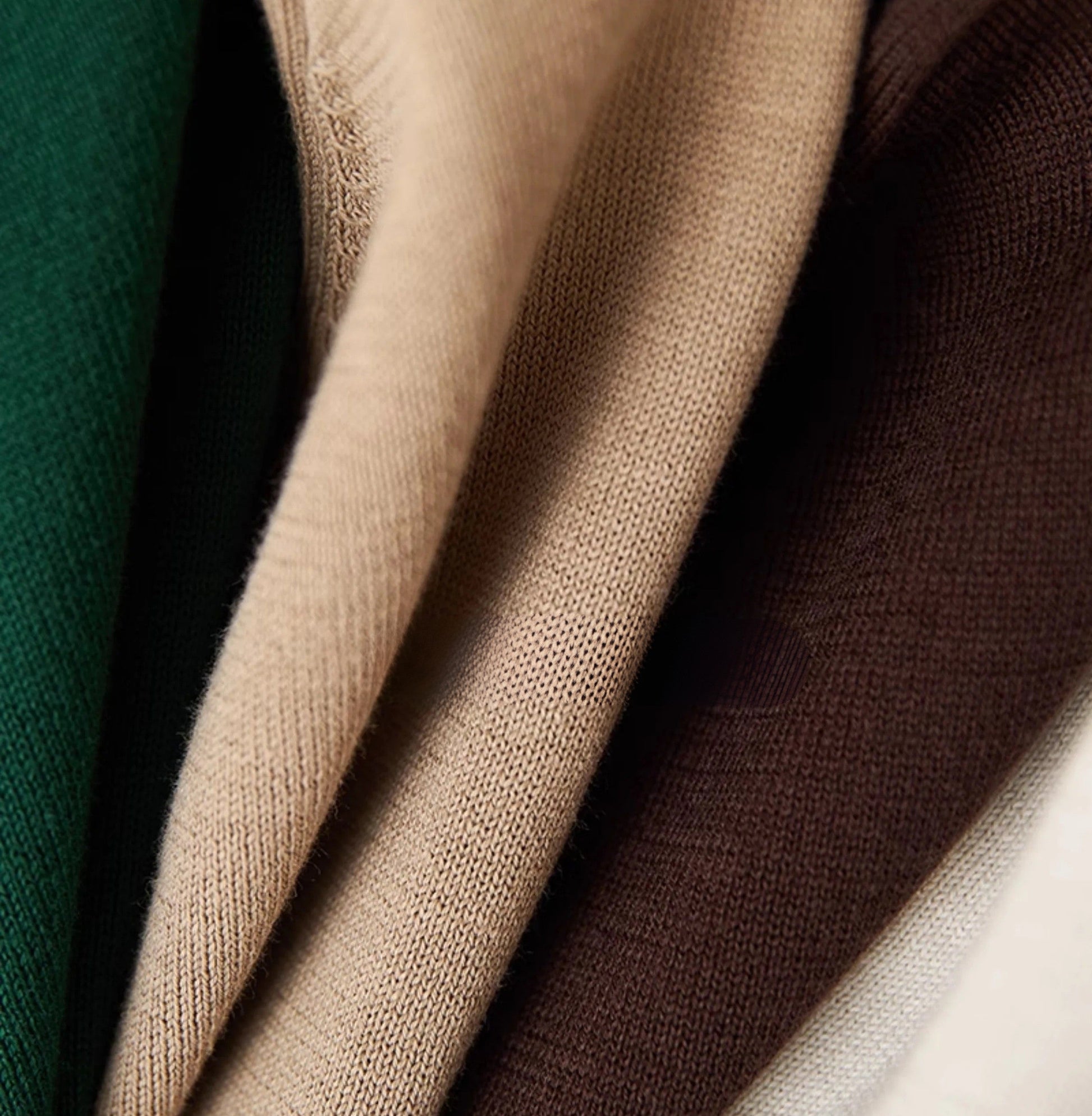 Men's crisp white 100% cotton polo featuring an intricate pointelle vertical ribbed texture and a refined buttoned placket.