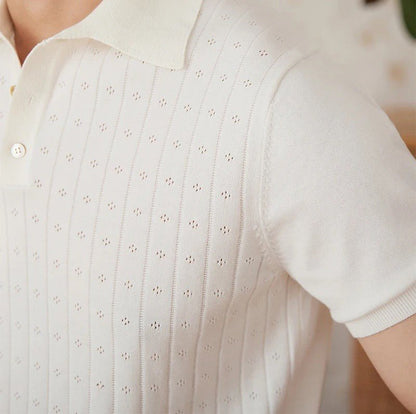 Men's crisp white 100% cotton polo featuring an intricate pointelle vertical ribbed texture and a refined buttoned placket.