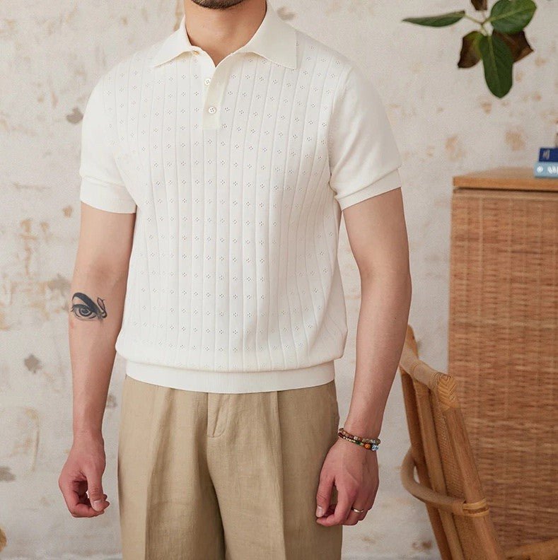 Men's crisp white 100% cotton polo featuring an intricate pointelle vertical ribbed texture and a refined buttoned placket.