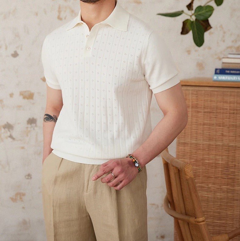 Men's crisp white 100% cotton polo featuring an intricate pointelle vertical ribbed texture and a refined buttoned placket.