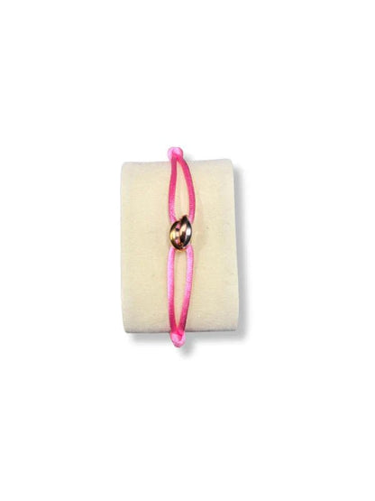 Pink bracelet with a gold charm on a white background