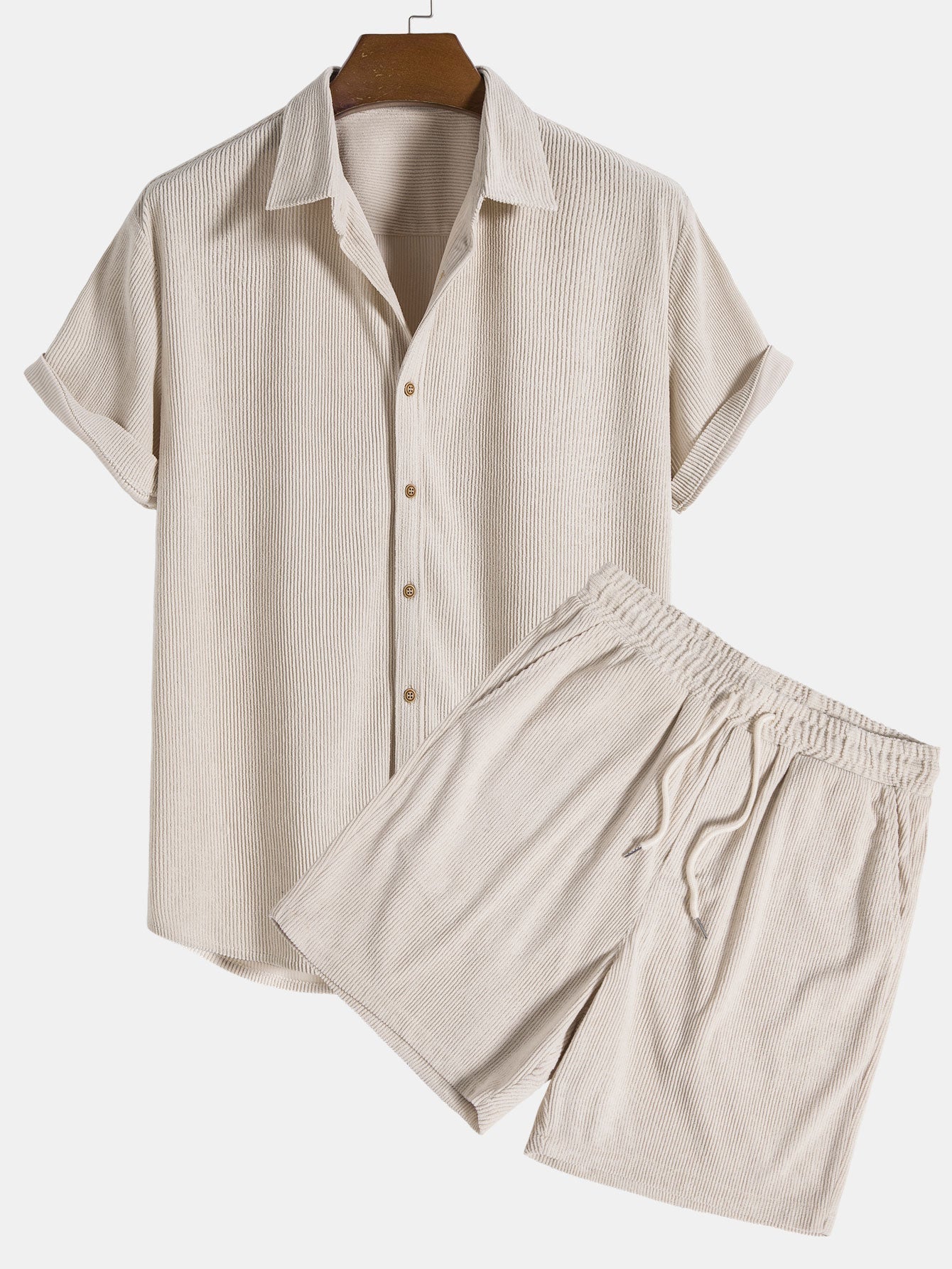 Beige short-sleeve shirt and pants set on a hanger against a white background