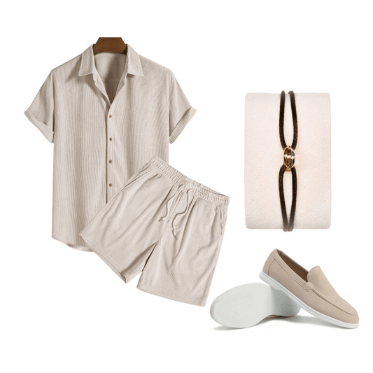 Beige shirt and shorts set with a necklace and loafers on a white background