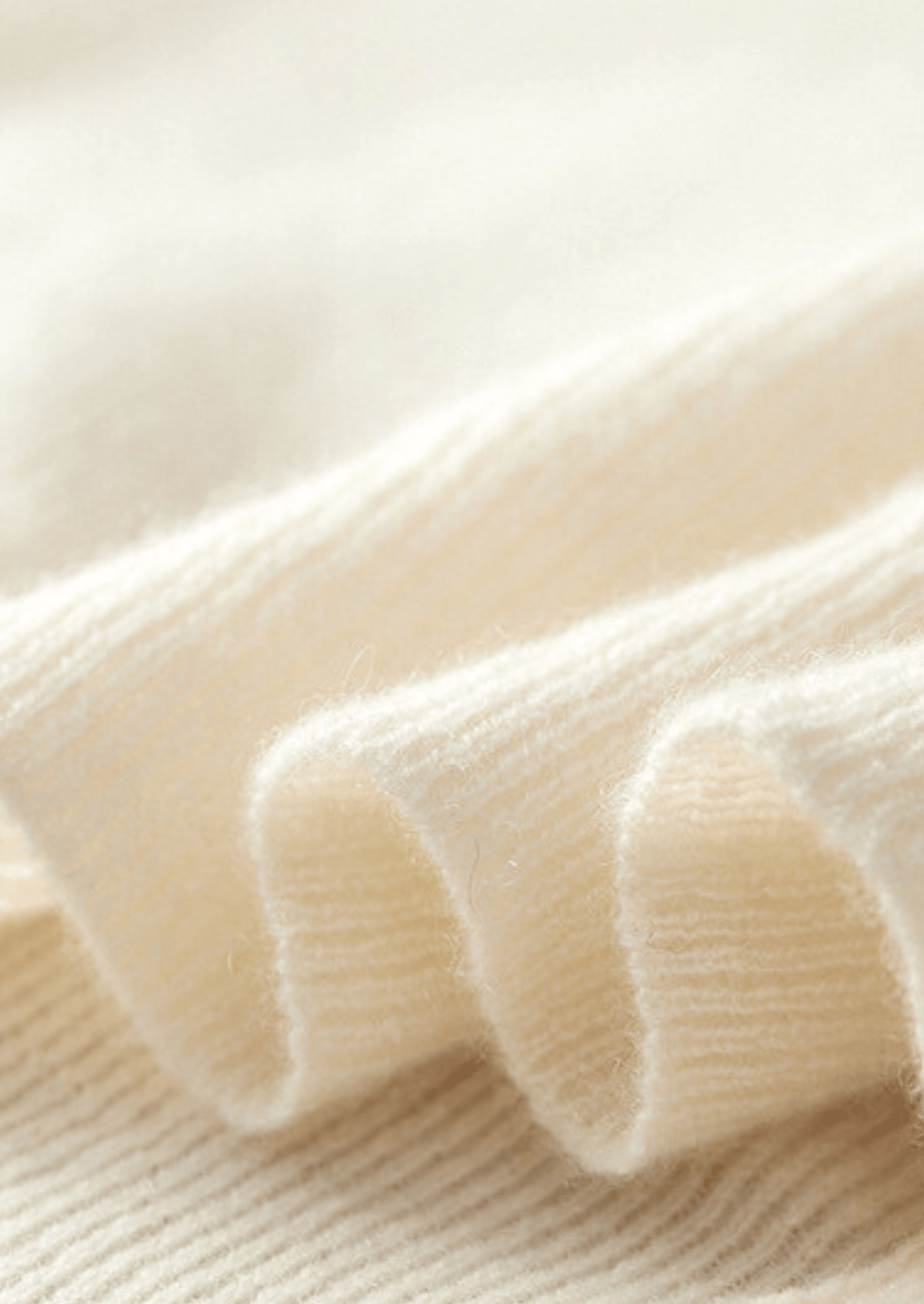 Close-up of the LORMIER cashmere vest zipper and ribbed mock-neck, highlighting the luxury texture and craftsmanship.