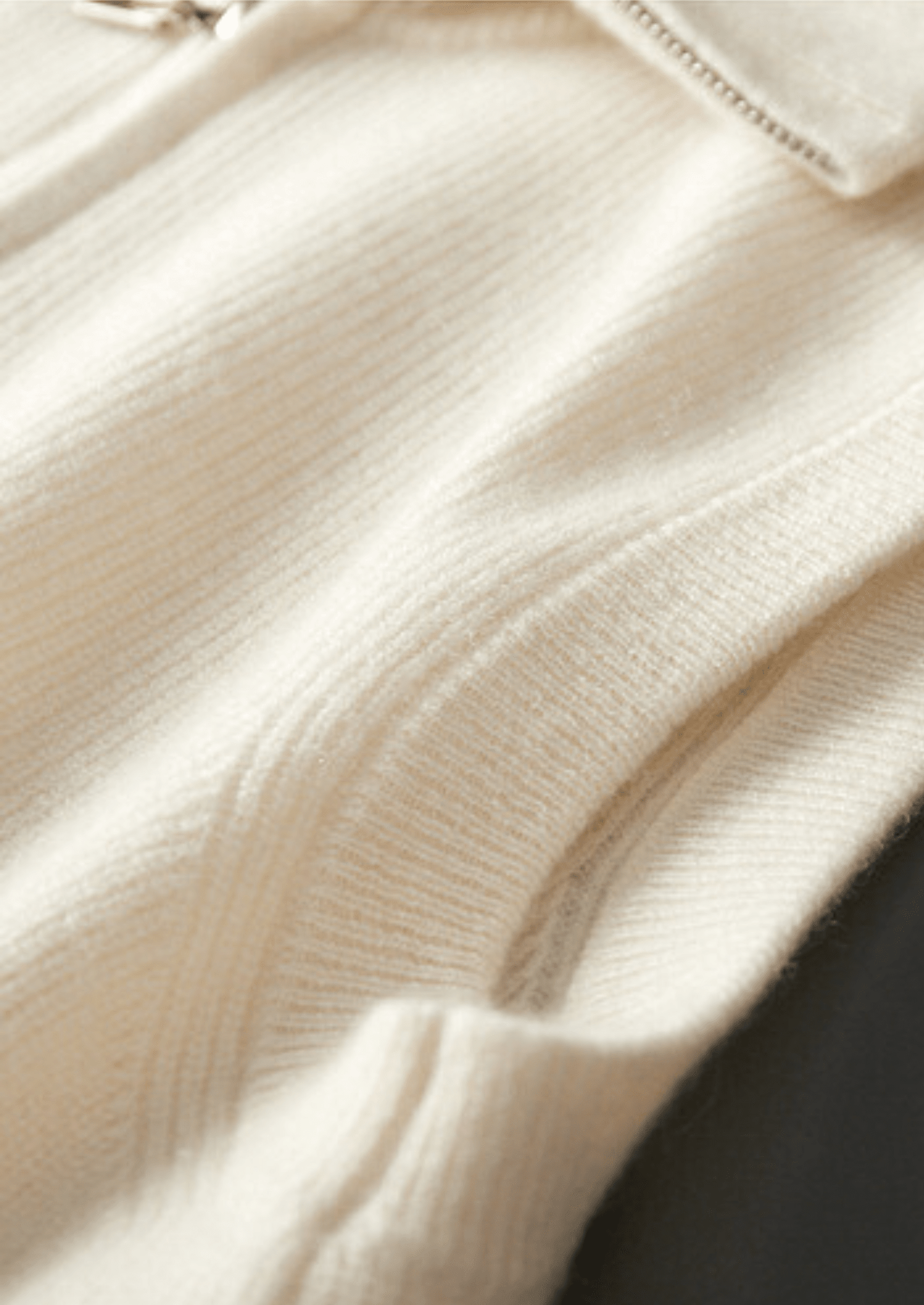 Close-up of the LORMIER cashmere vest zipper and ribbed mock-neck, highlighting the luxury texture and craftsmanship.