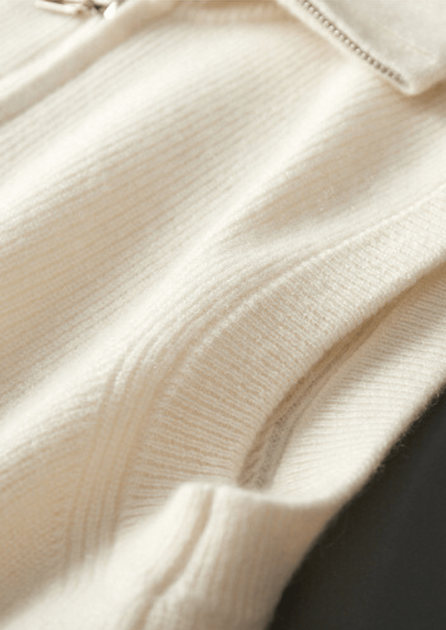 Close-up of the LORMIER cashmere vest zipper and ribbed mock-neck, highlighting the luxury texture and craftsmanship.