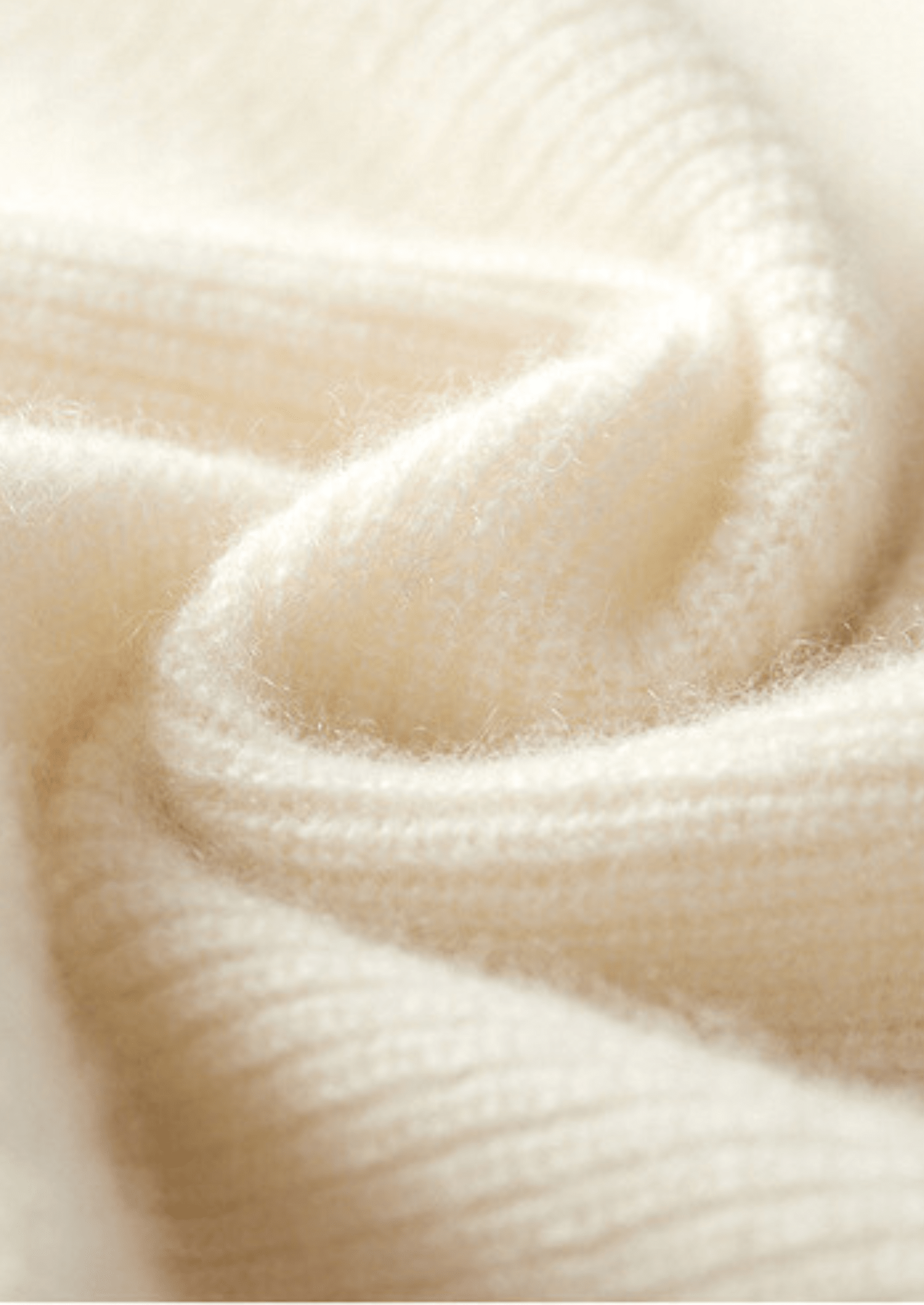 Close-up of the LORMIER cashmere vest zipper and ribbed mock-neck, highlighting the luxury texture and craftsmanship.