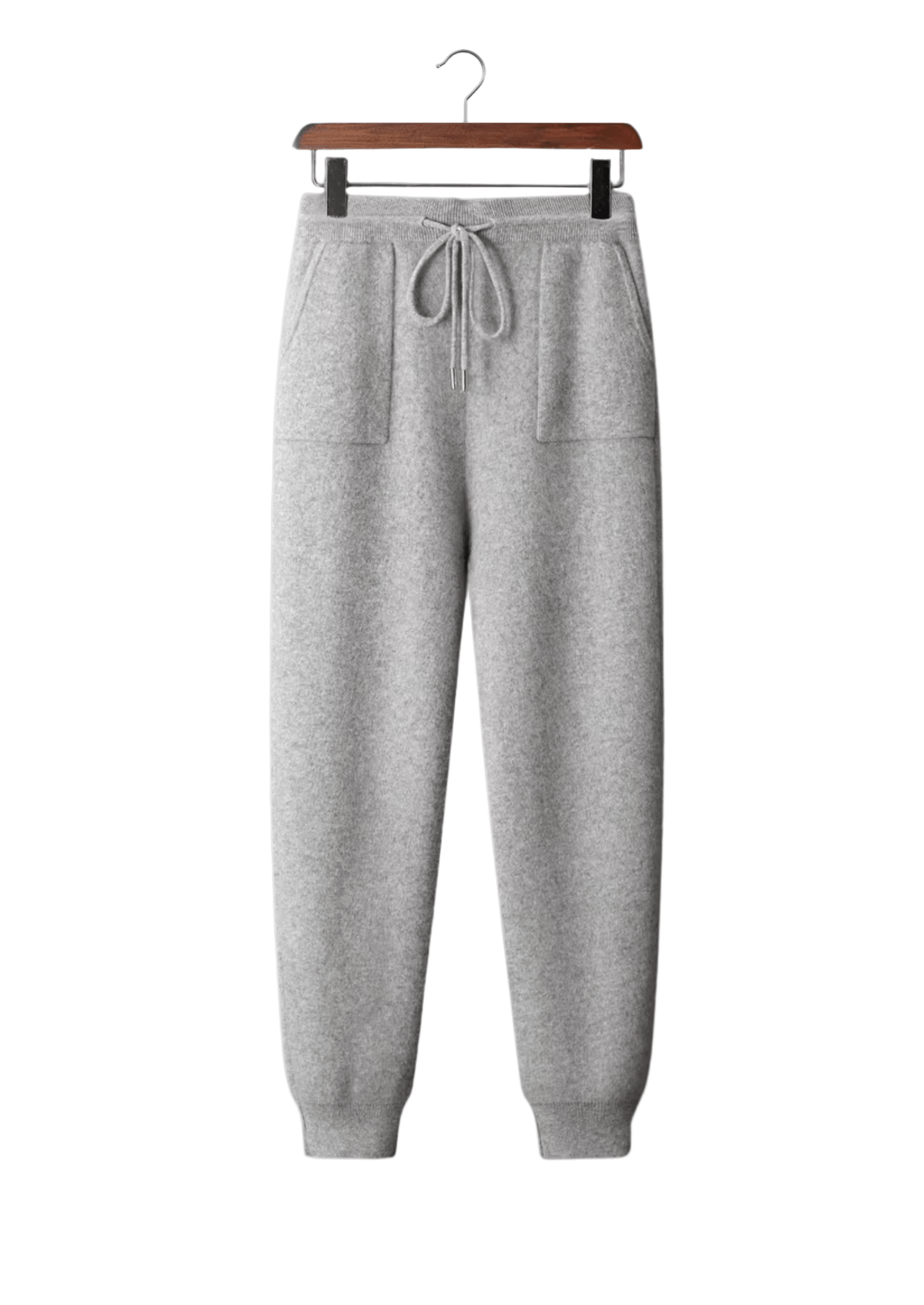 Gray sweatpants on a hanger against a white background