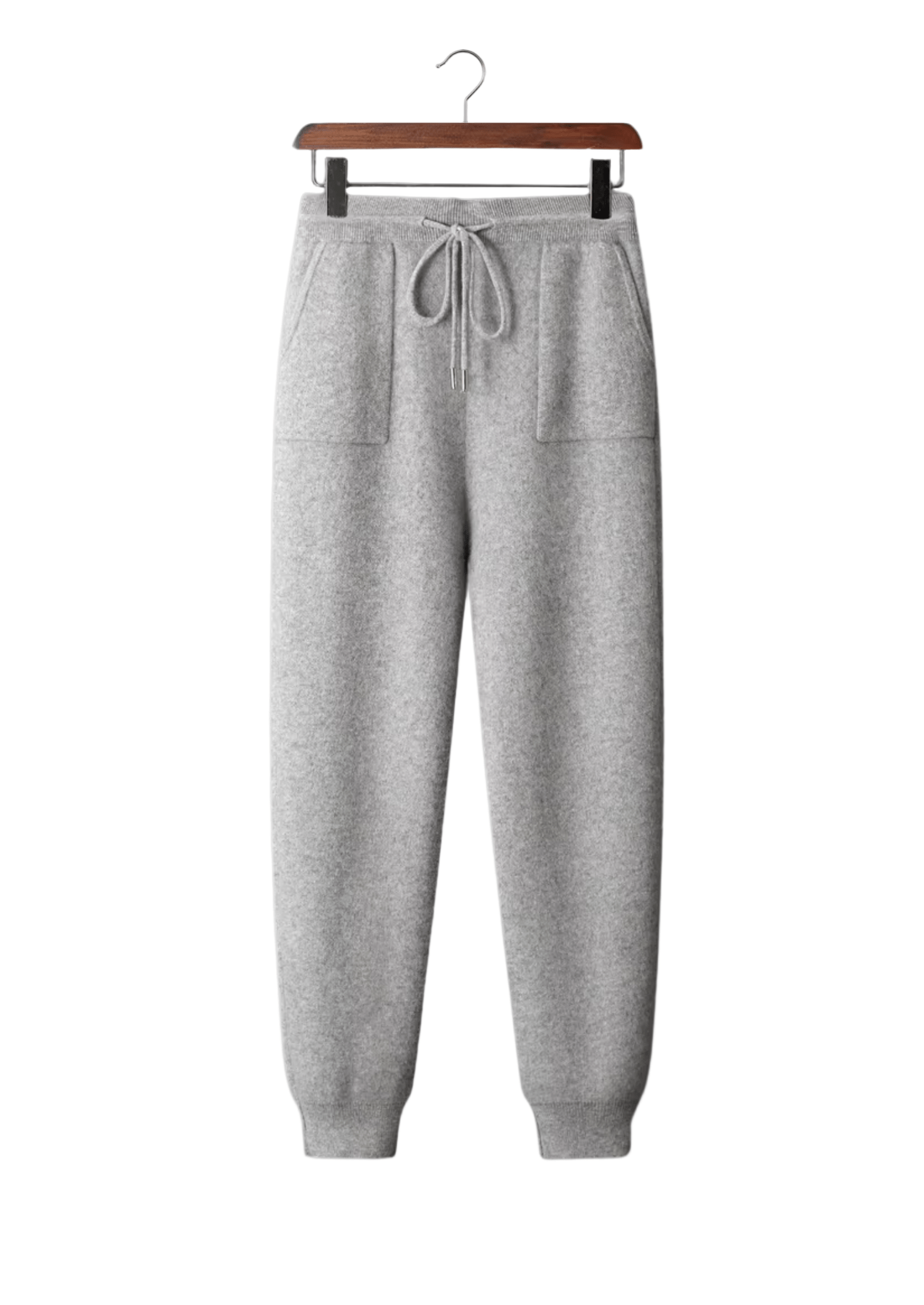 Gray sweatpants on a hanger against a white background